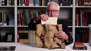 video still of Stephen Bury pulling book item out of bag