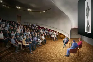 rendering of auditorium with full audience and speakers at front