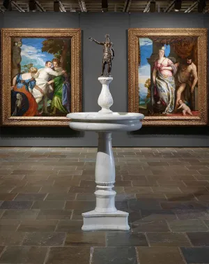 image of gallery with statuette situated between two large paintings