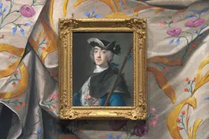 detail of portrait of man in black hat shown with colorful drapery