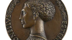 circular bronze medal with relief of woman in profile