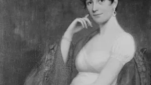 Half-length portrait of a young woman dressed in a short-sleeved white dress and a shawl in a chair.