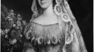 Half-length portrait of a woman wearing an embroidered dress,standing next to a bouquet of flowers.