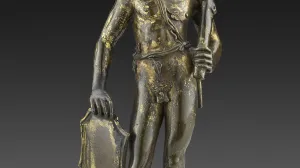 statue of man holding shield and club