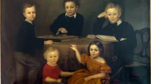 Group portrait of four young brothers and their young sister seated around a table.