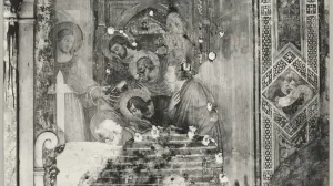 Religious wall fresco with chunks and sections of plaster missing from damage