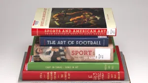Seven books about sports in art stacked