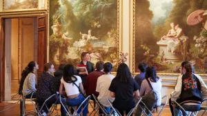 students in the Frick Collection gallery, with educator standing in front of paintings