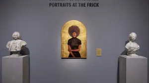 Arched gilded portrait of a woman with a large afro hairstyle between two marble busts