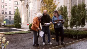 video still of three people in a garden