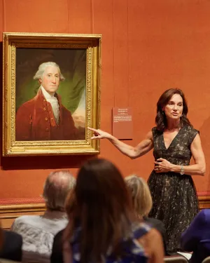 photo of Barratt giving talk in front of painting of George Washington