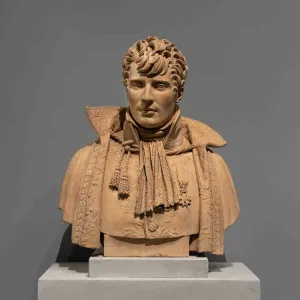Terracotta bust of a young man with a wide lacy collar, an imperial medal, and elaborate curly hair