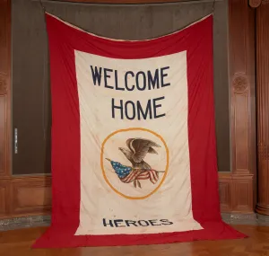 A large white banner with red border with the words 