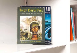 Two books stacked on a white shelf. The front book cover features an artwork detail of a shell-shocked soldier.