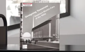 Book with a modern building on its cover on a library cart in front of a window