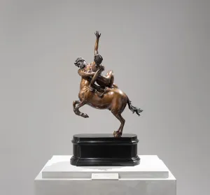 Bronze statuette on a pedestal of a centaur grasping a woman and rearing up on its hind legs