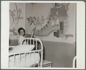Woman working on a children's mural in a hospital room