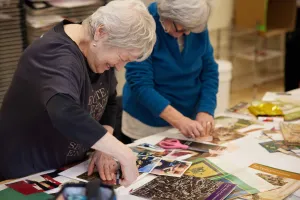 Two older women making collages