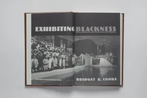 Title page spread of a book with an image of a museum gallery and the title "Exhibiting Blackness"