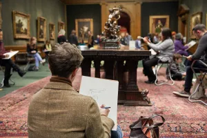 young man sketching in gallery