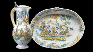 Earthenware pitcher and basin both depicting landscapes with figures and animals interacting.