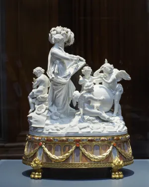 porcelain figure upon round base with gemstones