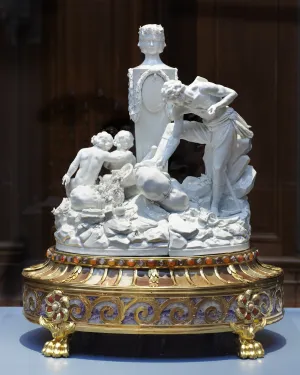 porcelain figures on round base with stones and gems