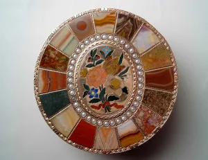 circular box with flowers of gemstones at center