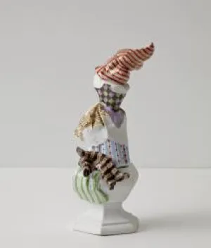 procelian sculpture with multi colored pieces and patterns on top of each other