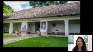 video still of Aimee Ng and building