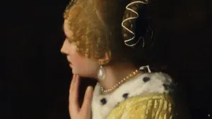 closeup of painting of woman in yellow dress with large pearl earring